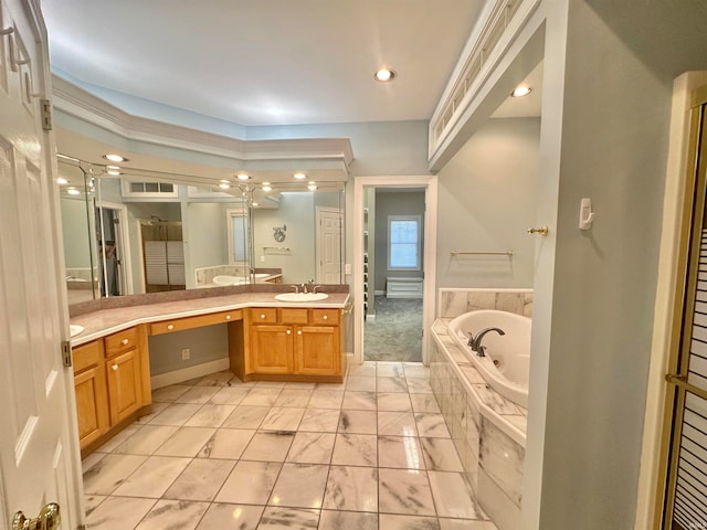 bathroom with vanity and a relaxing tiled tub