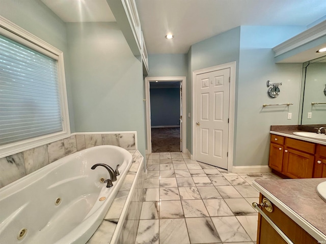 bathroom featuring tiled bath and vanity