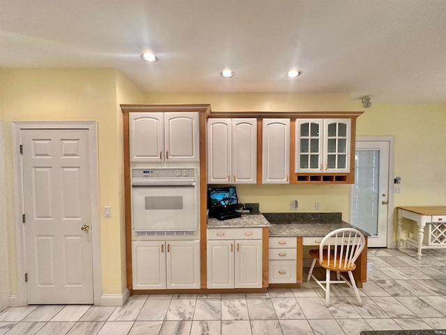 kitchen featuring built in desk and oven