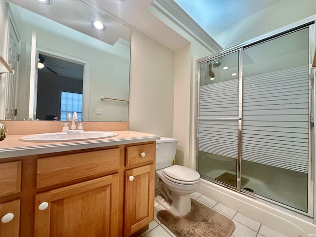 bathroom featuring ceiling fan, toilet, tile patterned floors, a shower with shower door, and vanity