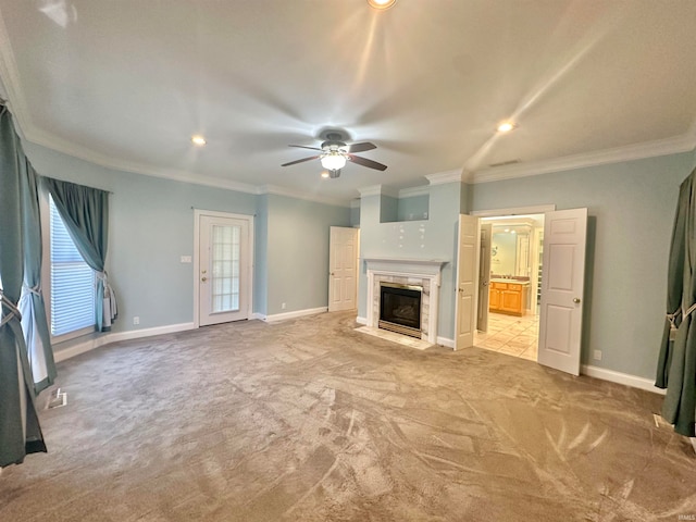 unfurnished living room with crown molding, light colored carpet, and ceiling fan