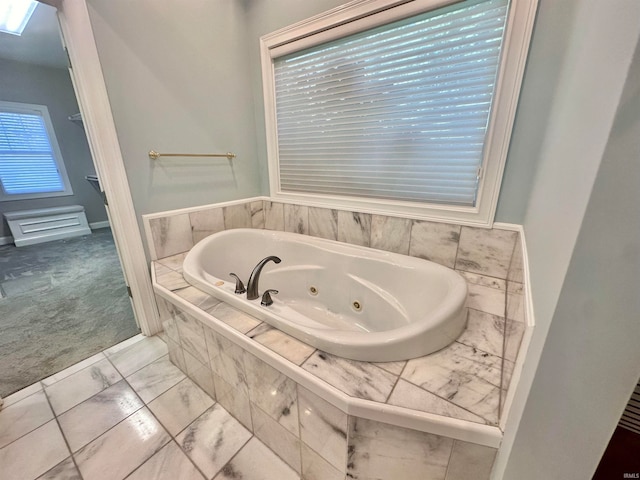 bathroom featuring a relaxing tiled tub