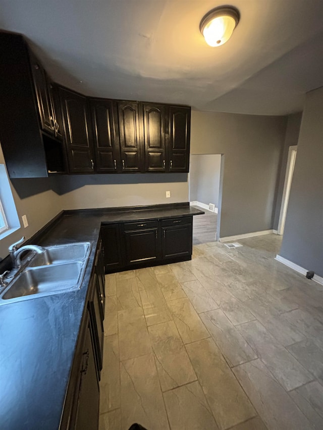 kitchen with dark brown cabinets and sink