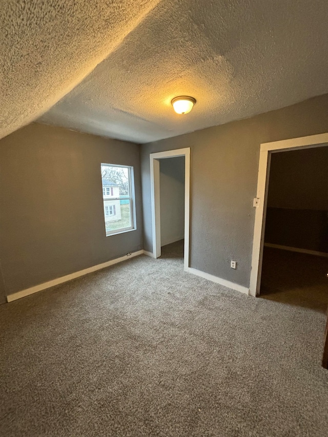 interior space with carpet, a textured ceiling, and a closet