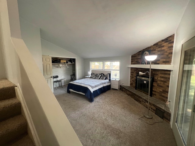 bedroom featuring a brick fireplace, carpet flooring, and vaulted ceiling