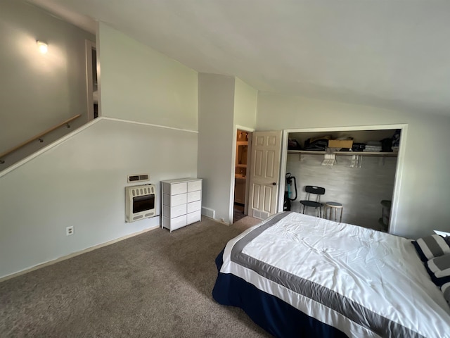 bedroom featuring vaulted ceiling, heating unit, a closet, and dark colored carpet