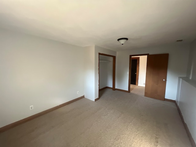 interior space featuring a closet and carpet