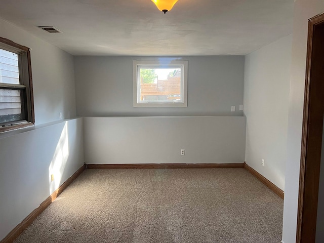 spare room featuring carpet and a healthy amount of sunlight