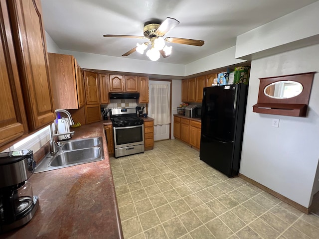 kitchen featuring appliances with stainless steel finishes, ceiling fan, sink, and tasteful backsplash