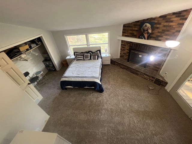 bedroom featuring a fireplace, a closet, and carpet