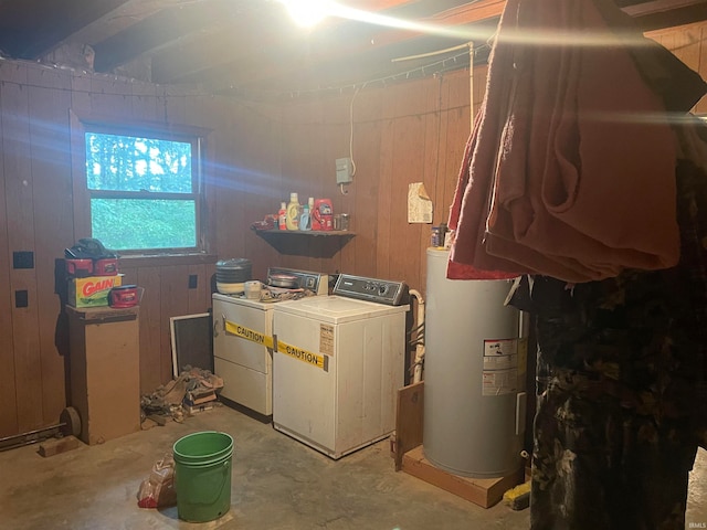 washroom featuring separate washer and dryer, wood walls, and electric water heater