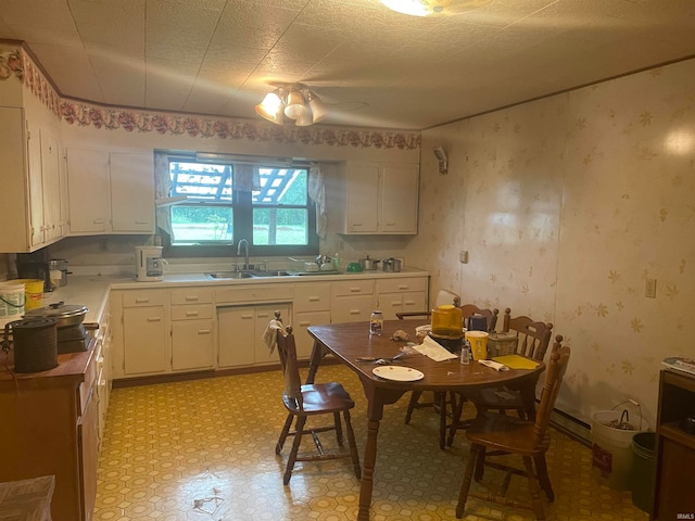 kitchen featuring white cabinets, sink, and a textured ceiling