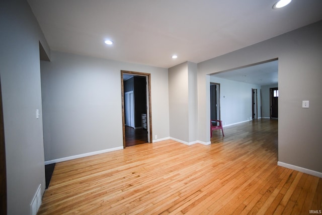 empty room with light hardwood / wood-style flooring