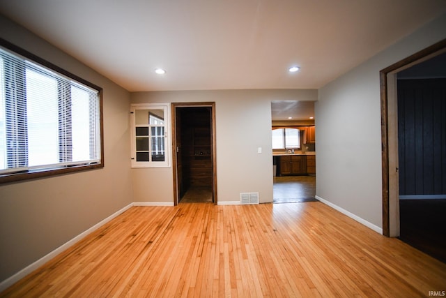 empty room with light wood-type flooring and sink