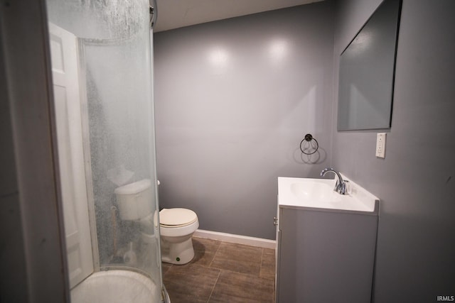 bathroom featuring tile patterned flooring, a shower, vanity, and toilet