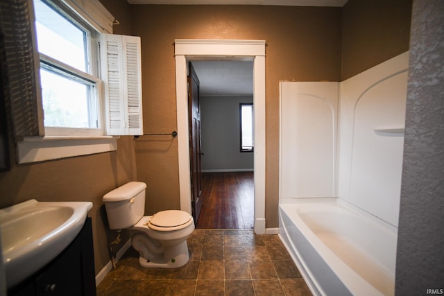 full bathroom featuring tub / shower combination, hardwood / wood-style flooring, vanity, and toilet