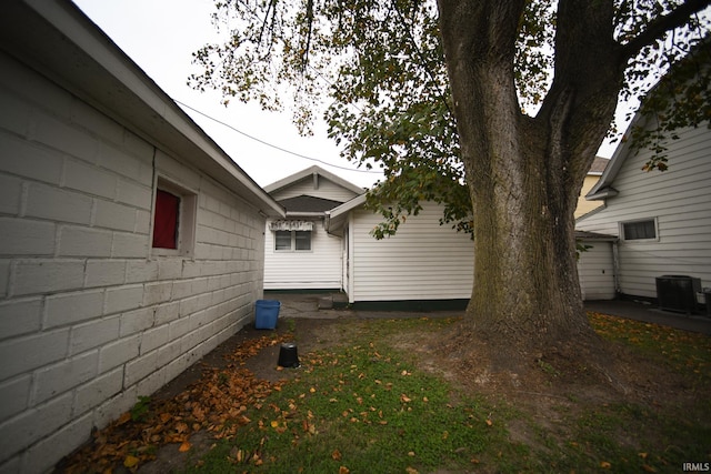 view of side of property with central air condition unit