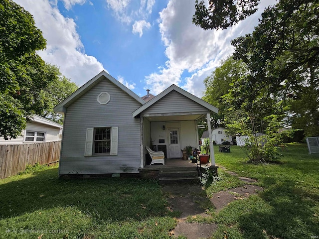 view of front of home with a front yard and covered porch