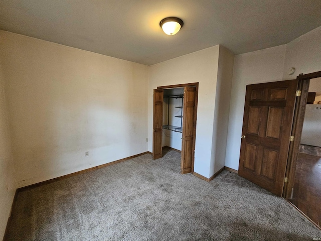 unfurnished bedroom featuring carpet flooring and a closet