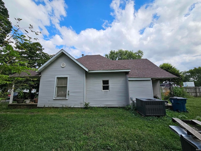 view of property exterior featuring cooling unit and a lawn