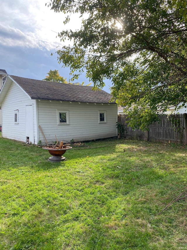 rear view of house featuring a lawn