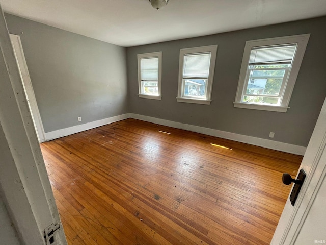 unfurnished room with hardwood / wood-style flooring