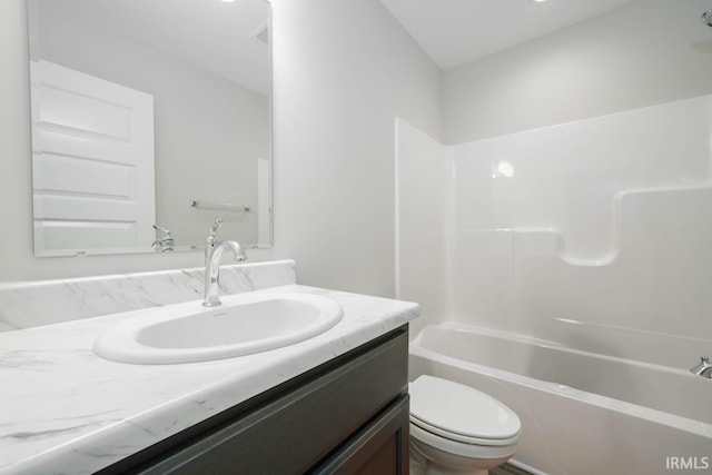 full bathroom featuring tub / shower combination, vanity, and toilet