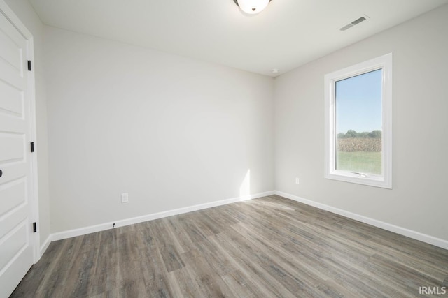 unfurnished room featuring dark wood-type flooring