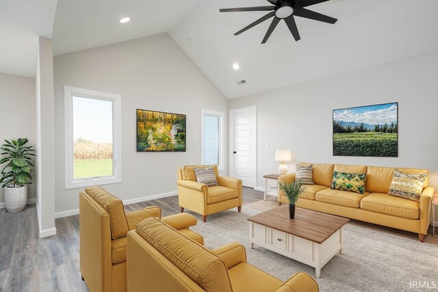 living room with high vaulted ceiling, wood finished floors, ceiling fan, baseboards, and recessed lighting