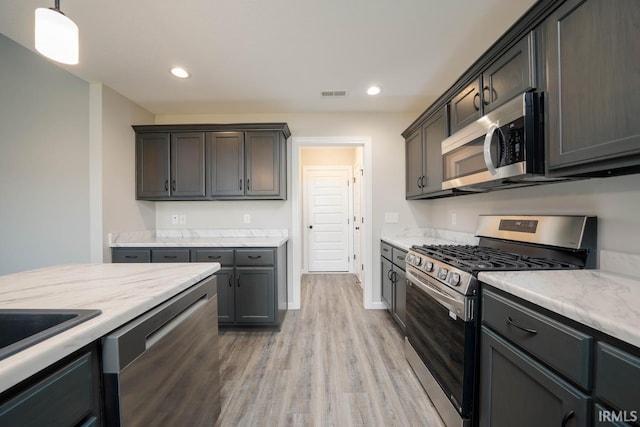 kitchen featuring recessed lighting, light wood-type flooring, visible vents, and stainless steel appliances