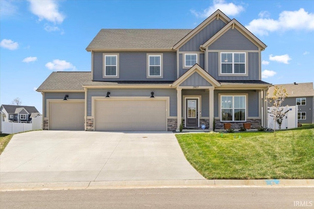 craftsman-style house with a garage and a front lawn