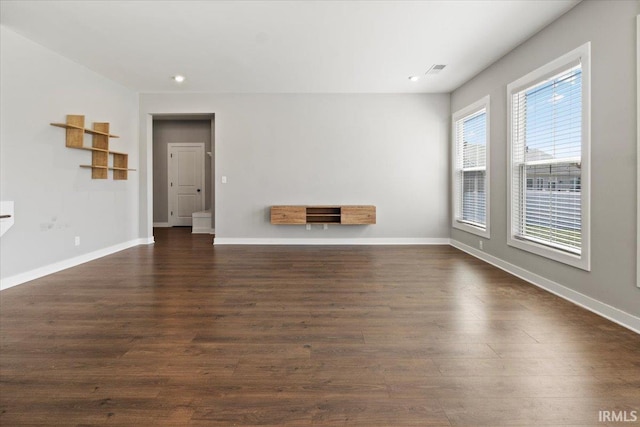 unfurnished living room with dark hardwood / wood-style floors