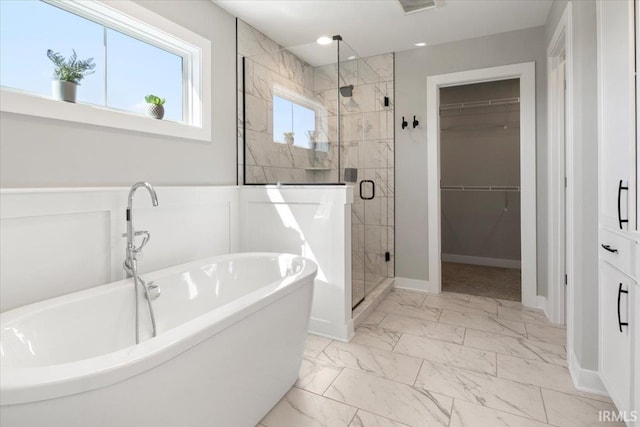 bathroom featuring separate shower and tub