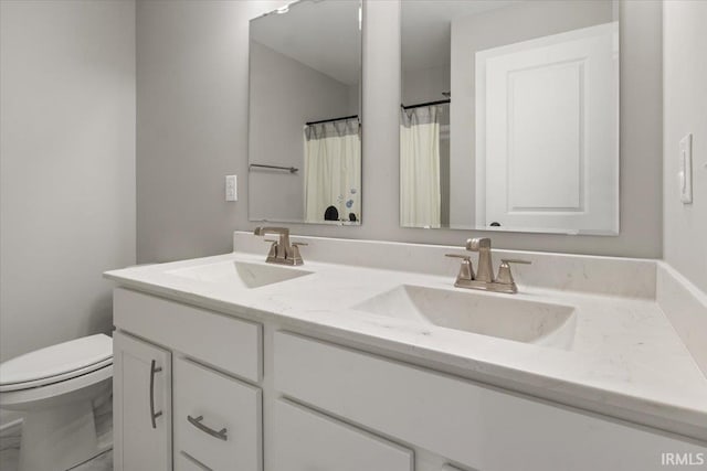 bathroom featuring toilet and vanity