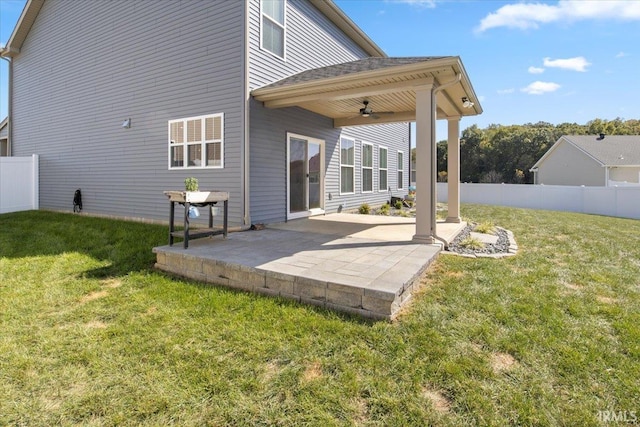 rear view of house with a yard, ceiling fan, and a patio