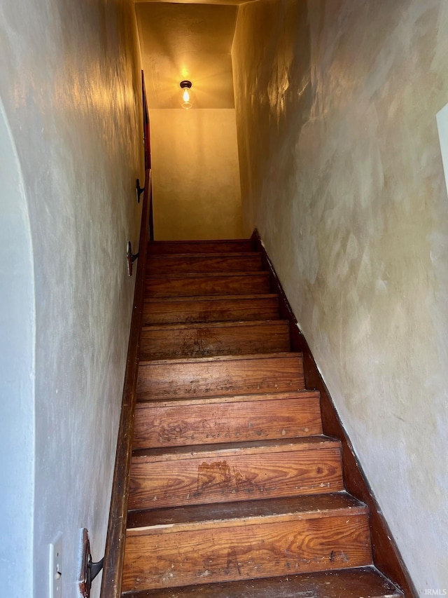 stairs featuring wood-type flooring