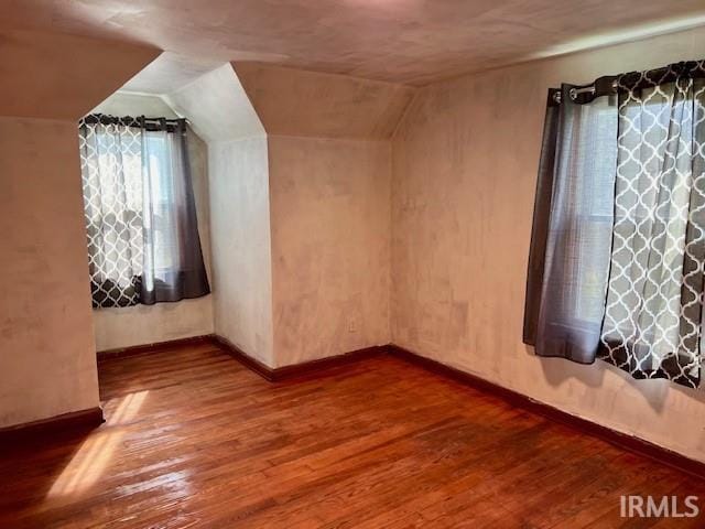 bonus room featuring hardwood / wood-style floors and vaulted ceiling