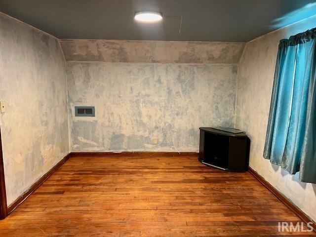 empty room with hardwood / wood-style floors