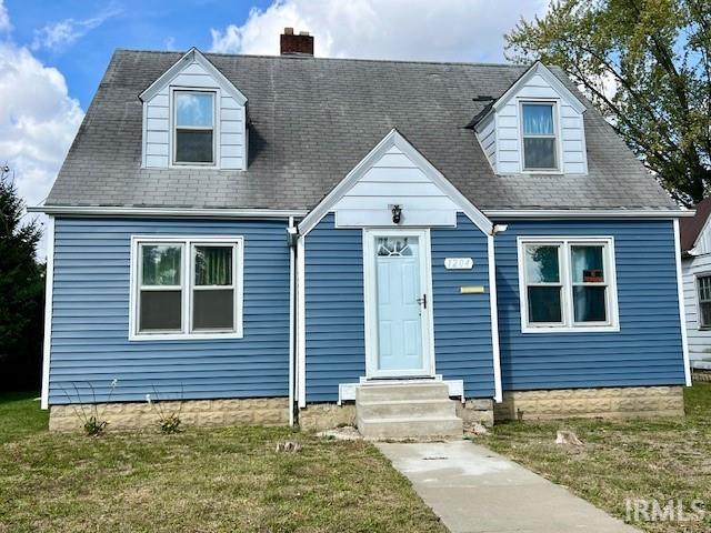 cape cod-style house with a front lawn