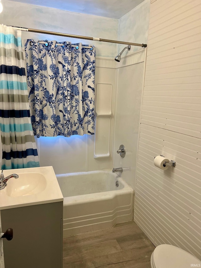 full bathroom featuring vanity, shower / tub combo with curtain, toilet, and wood-type flooring