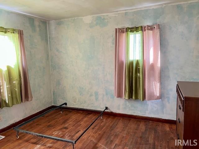 unfurnished room featuring a healthy amount of sunlight and hardwood / wood-style floors