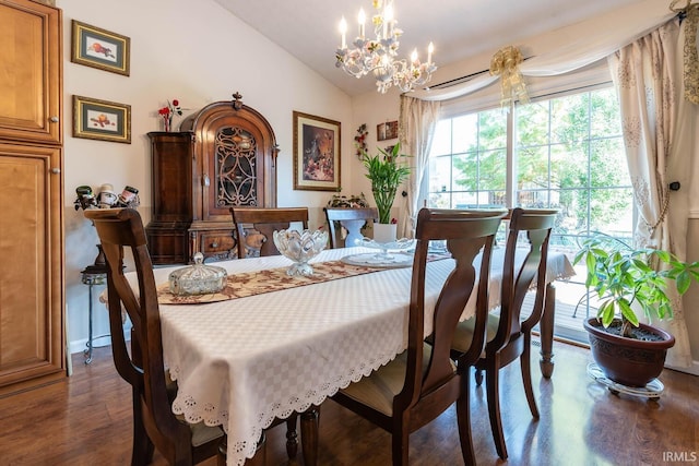 dining area featuring a notable chandelier, dark hardwood / wood-style floors, and vaulted ceiling