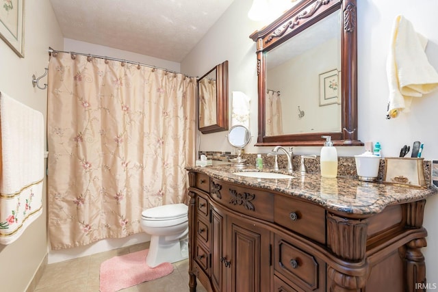 bathroom with vanity, toilet, curtained shower, a textured ceiling, and tile patterned flooring