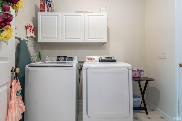 washroom featuring separate washer and dryer and cabinets