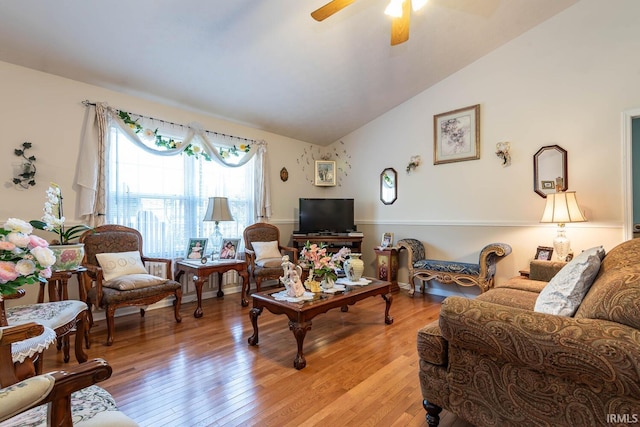 living room with lofted ceiling, light hardwood / wood-style floors, and ceiling fan