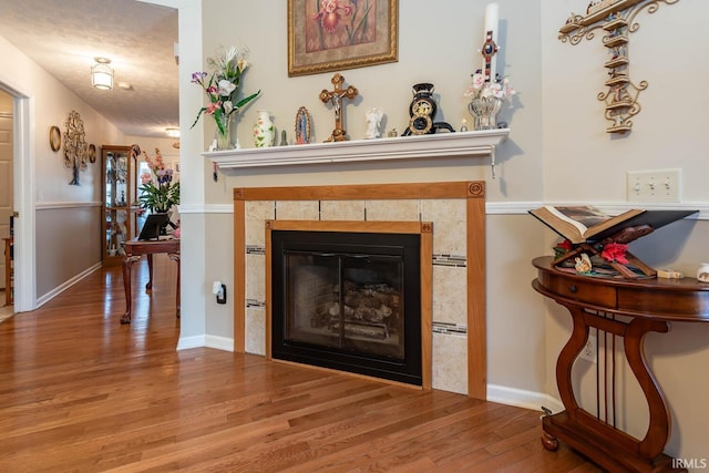 details featuring hardwood / wood-style flooring, a fireplace, and a textured ceiling