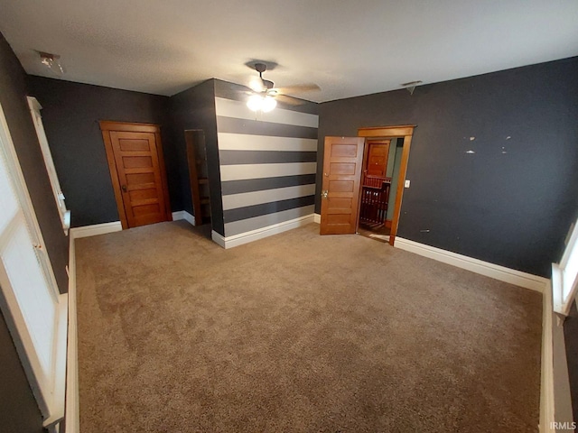 unfurnished bedroom with ceiling fan and carpet