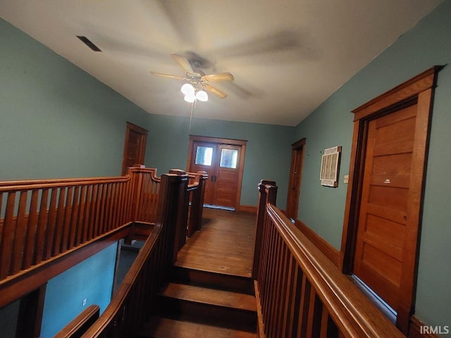 staircase featuring hardwood / wood-style flooring and ceiling fan