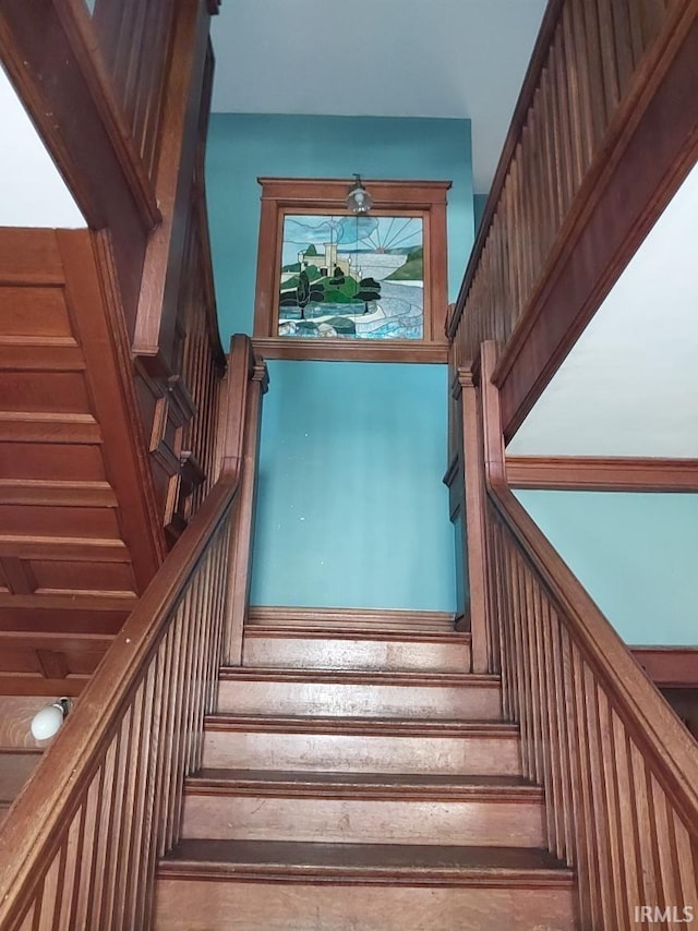 staircase featuring wood-type flooring