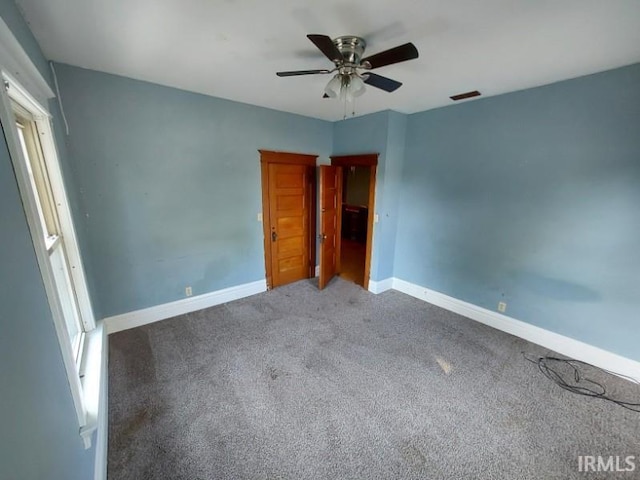 unfurnished bedroom with carpet flooring and ceiling fan